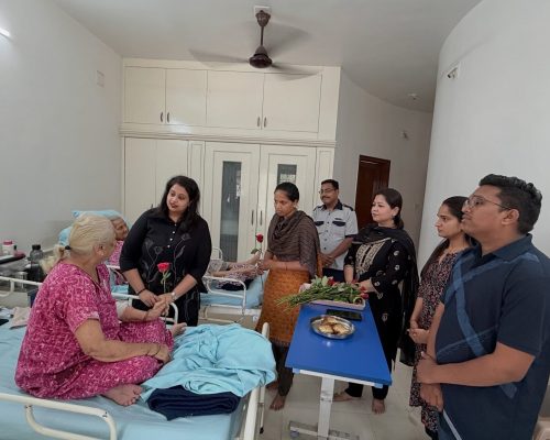Atman Care Home team giving roses to elderly residents