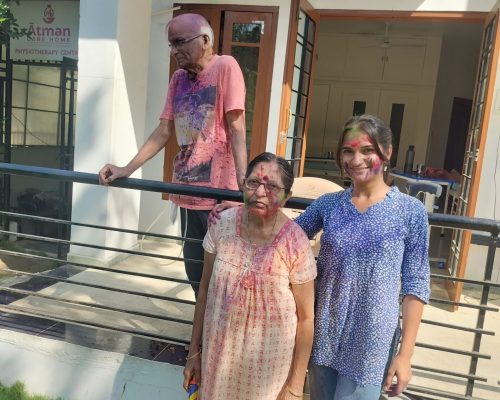 Caregiver celebrating Holi with seniors