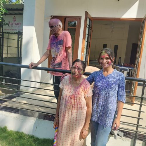 Caregiver celebrating Holi with seniors
